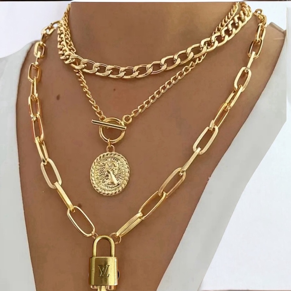 #312 Louis Vuitton lock and key with unbranded necklace.